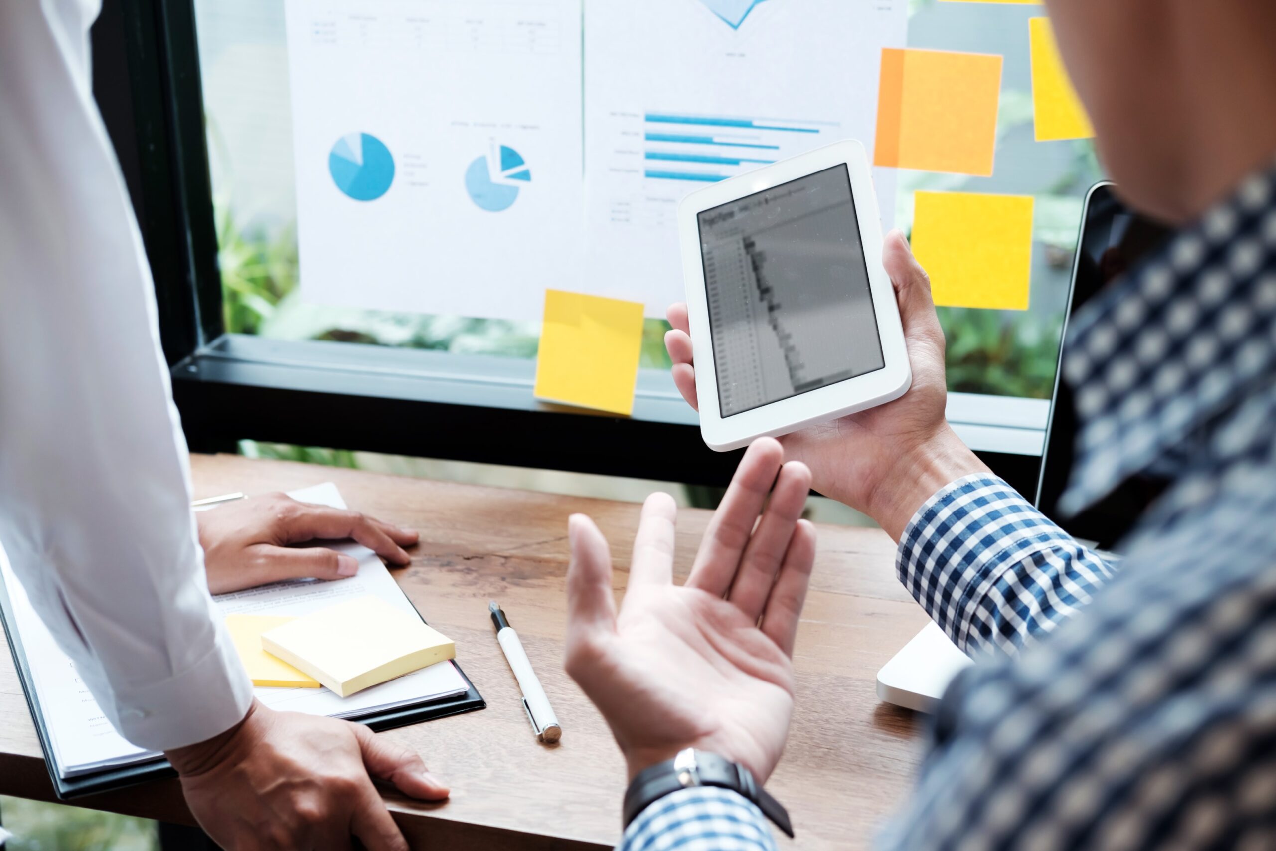 Quality professionals reviewing performance metrics using QMS tools