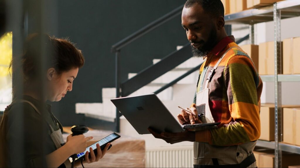 Coworkers using manufacturing QMS software