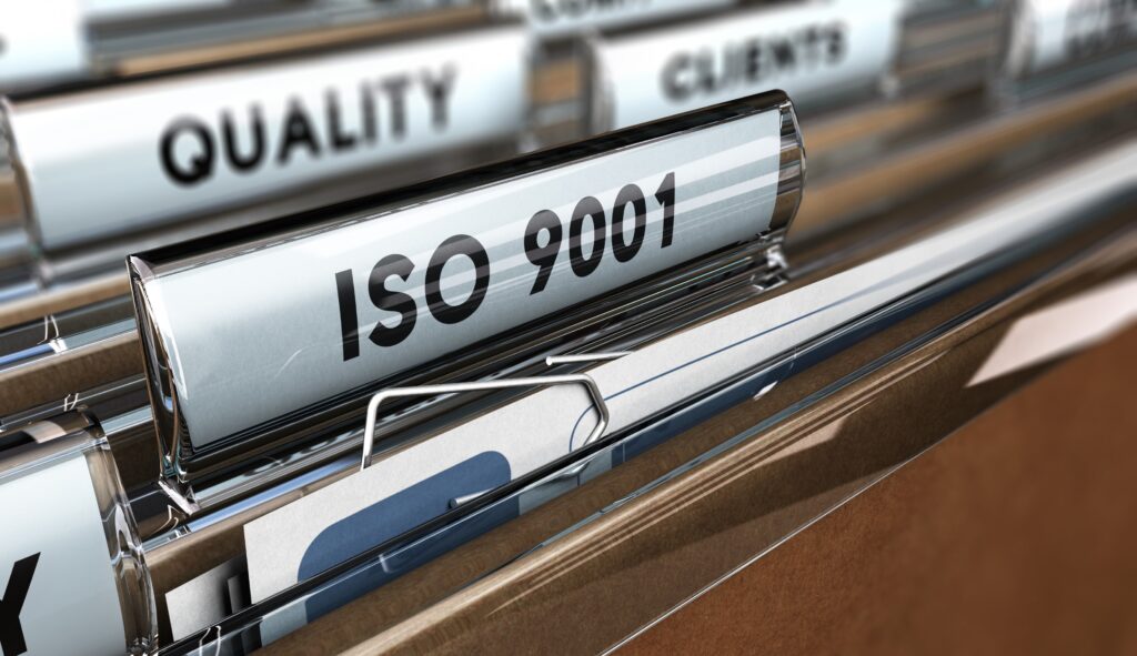 Close-up of ISO 9001 quality documents organized for an ISO audit checklist review