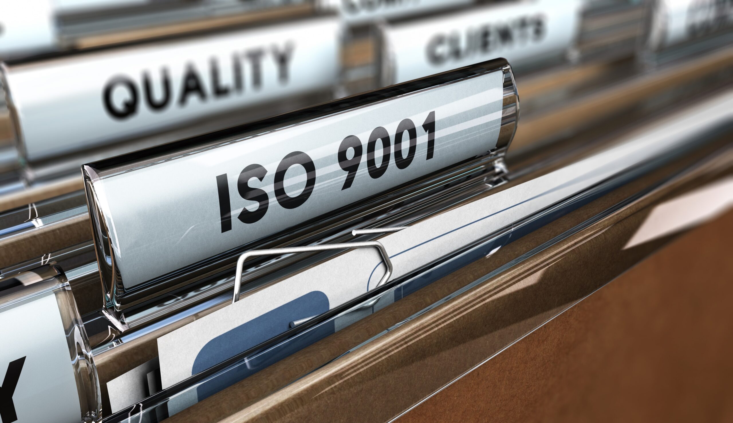 Close-up of ISO 9001 quality documents organized for an ISO audit checklist review