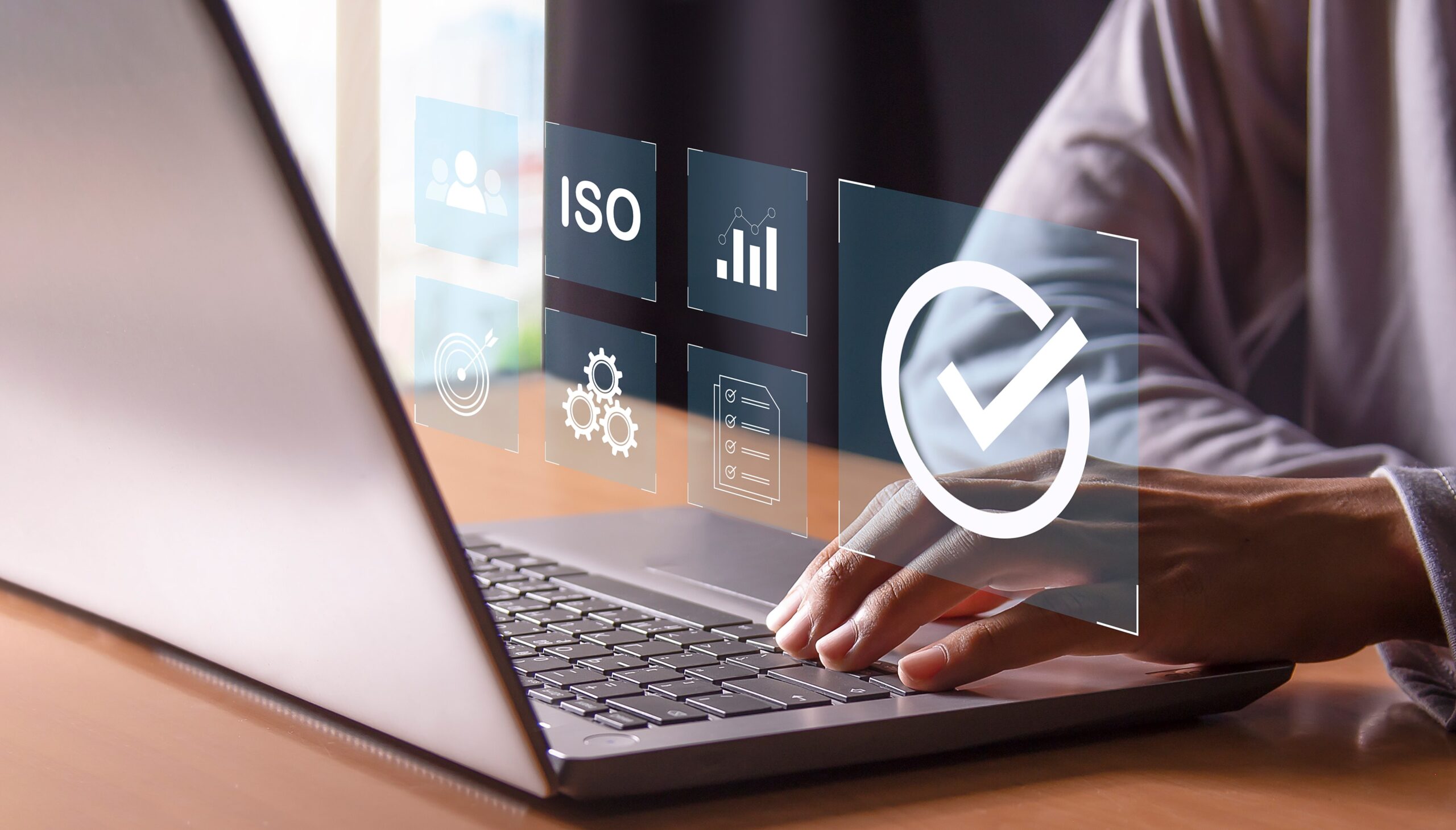 ISO audit software showing compliance checks and audit status on a laptop