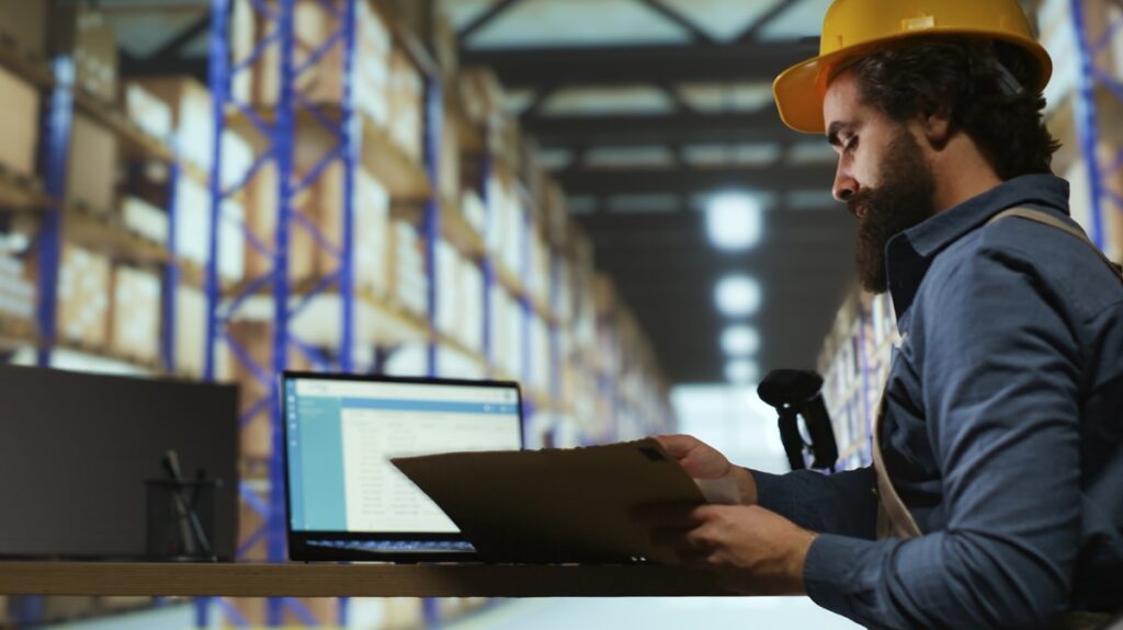Employee using software for quality control in manufacturing