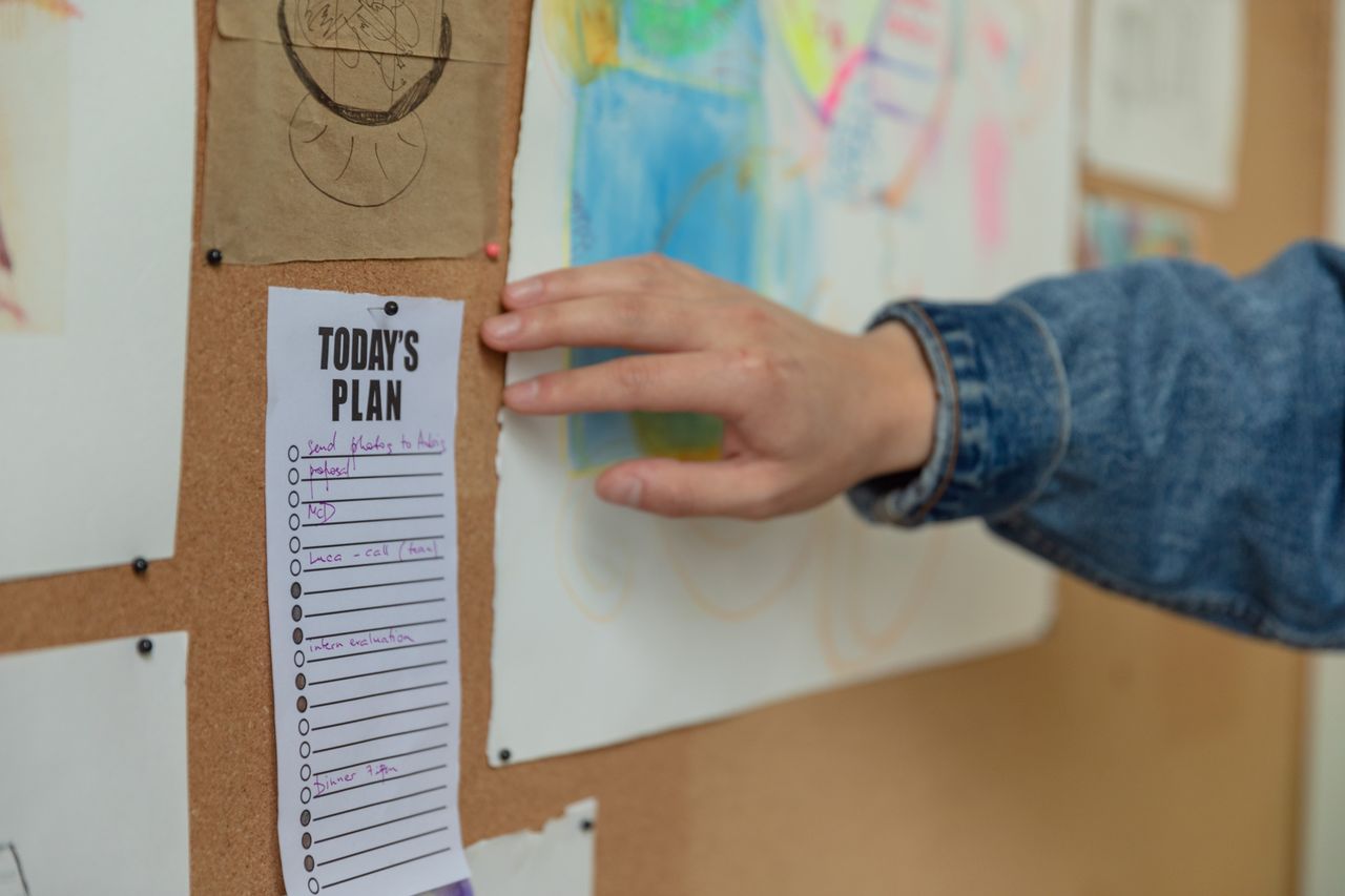 A daily plan checklist pinned to a board