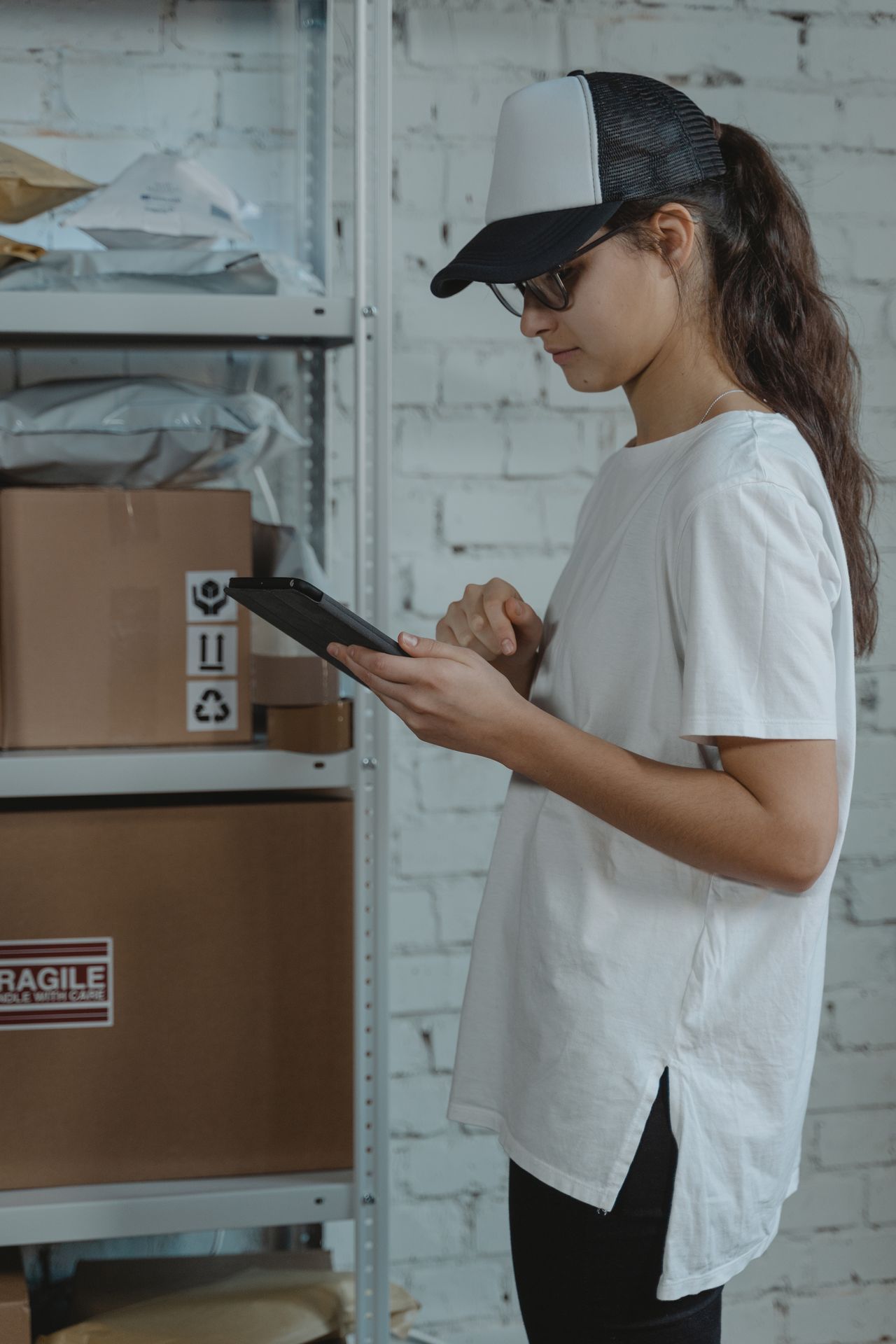 A receiving worker checking incoming boxes against a tablet