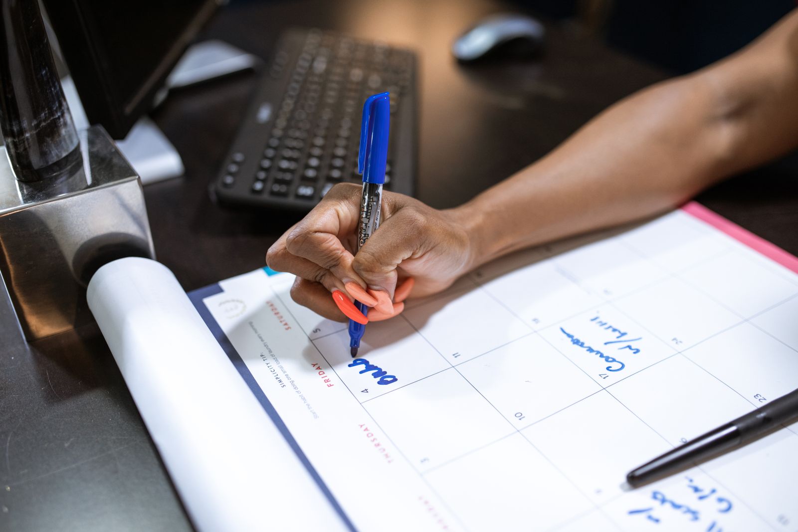 Marking time off on a planning calendar at a work desk
