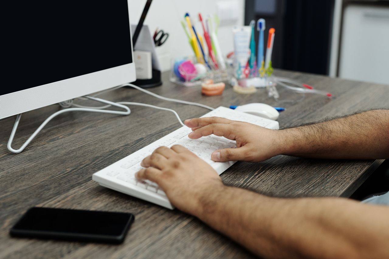 A power user driving the TLM Main App at a desktop keyboard