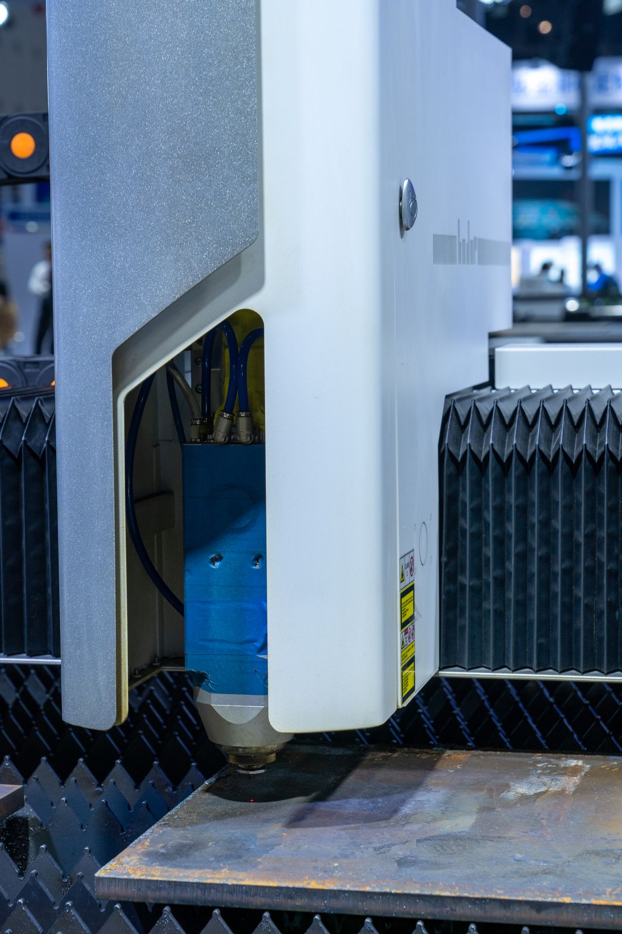 A modern CNC laser cutter on a manufacturing floor