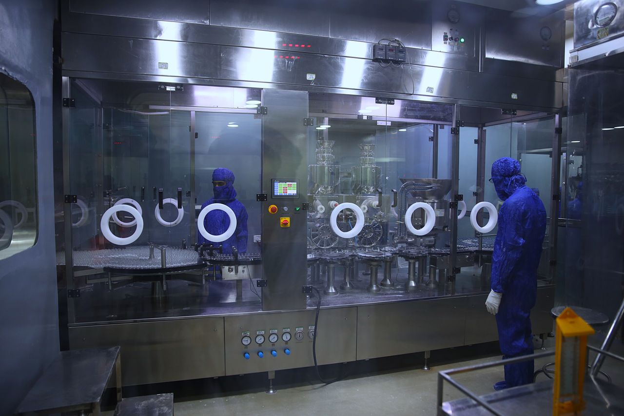 Technicians on a sterile medical-device manufacturing line