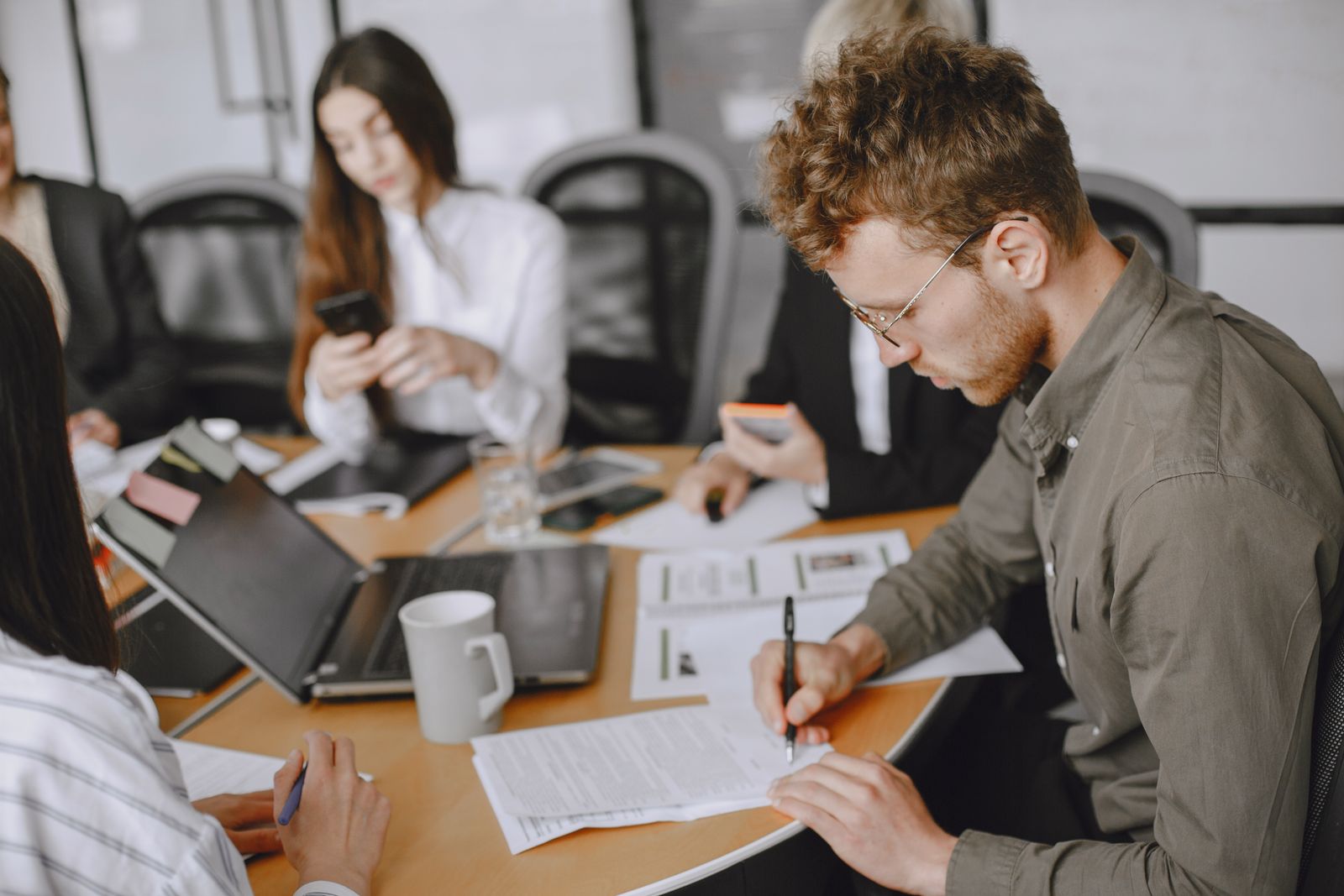 A team in a review meeting capturing minutes and actions