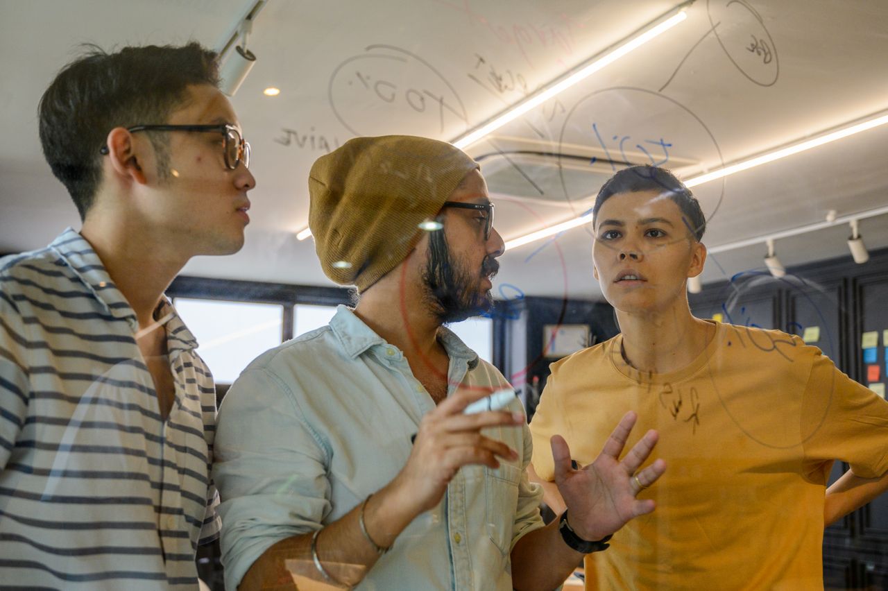 A team collaborating on a project plan at a board