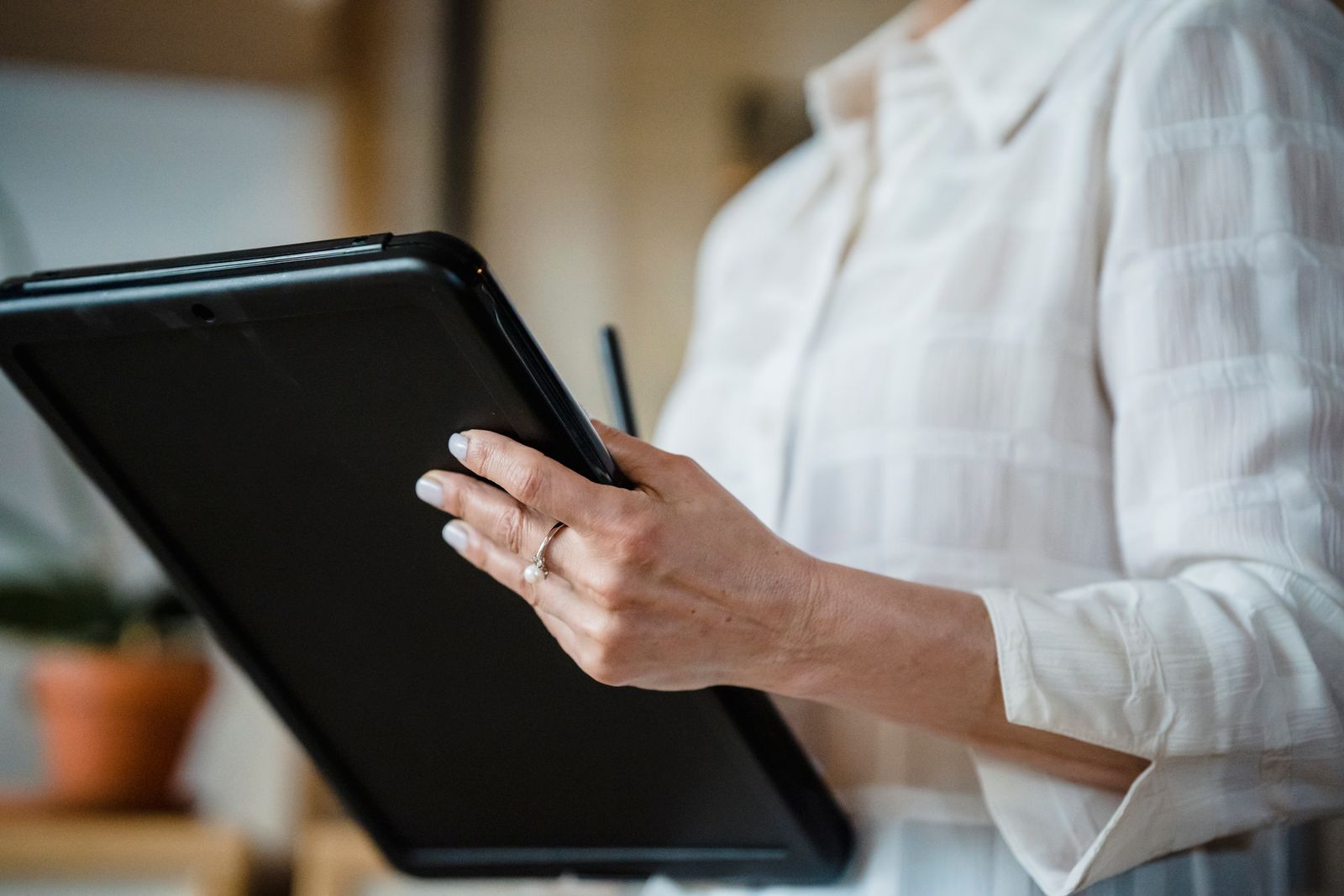 A person completing a survey on a tablet